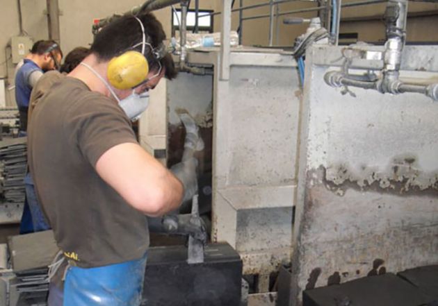 Mit Spaltmeißel und Holzhammer werden aus dem Rohschiefer ca. 5 mm dicke Platten gespalten